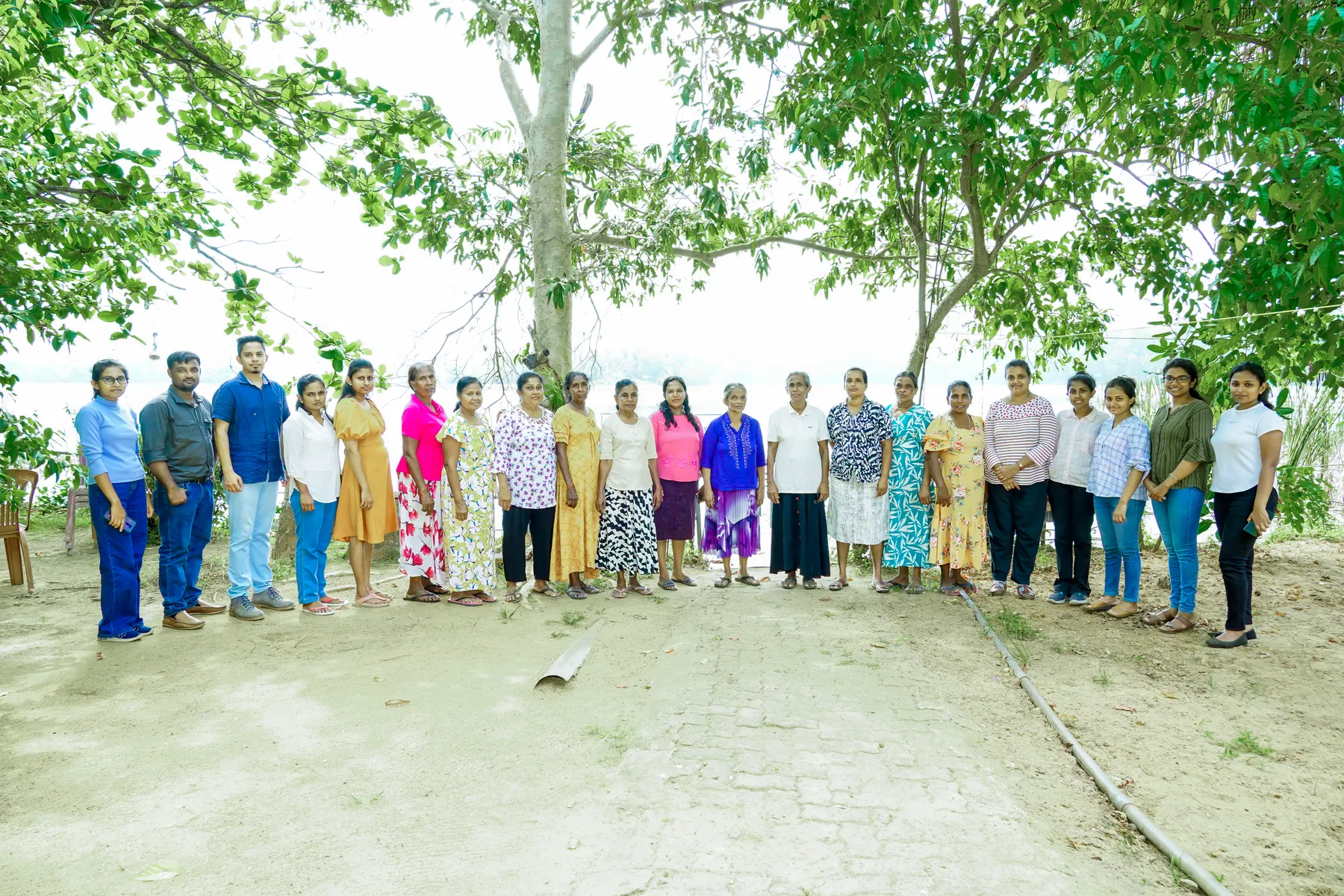 Women fish processors and workshop facilitators standing together outdoors