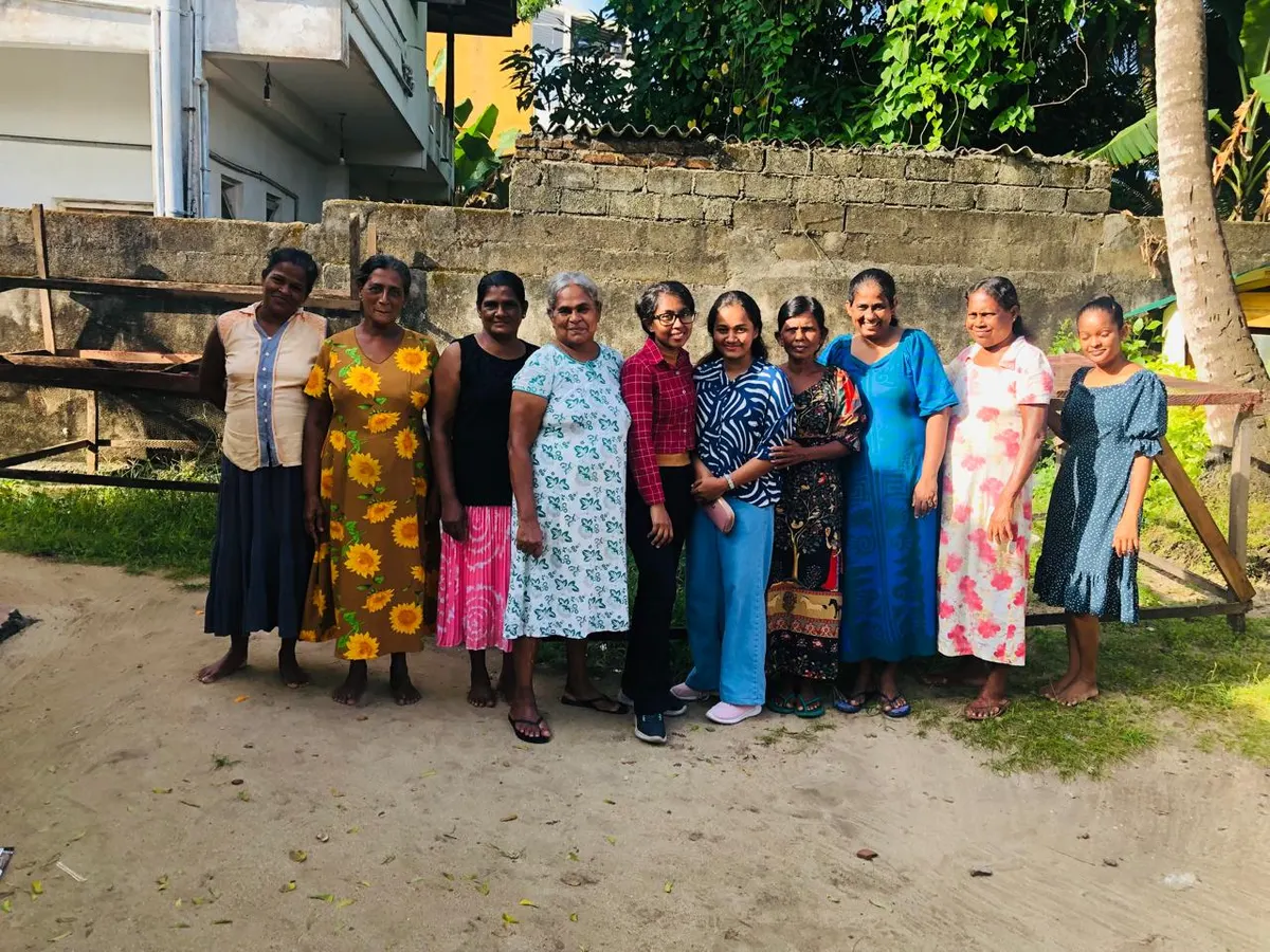 Women fish processors standing together in a village